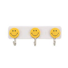 Colorful smiley face hooks for decorative wall hanging.