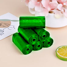 Green biodegradable trash bag rolls for household waste management.